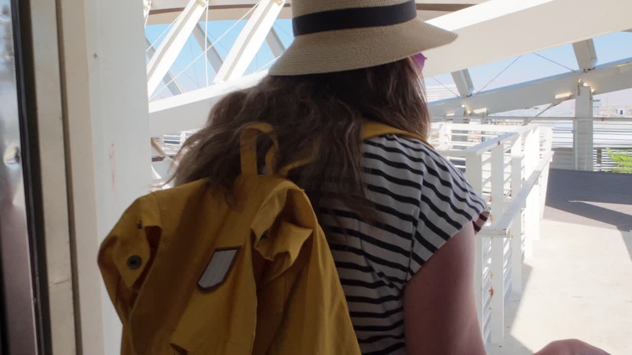 Female Traveler Exiting Elevator Towards Boarding Bridge