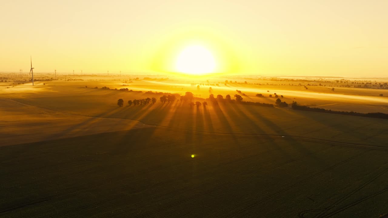Aerial sunrise view with wind turbines evoking heatwaves and environmental risk