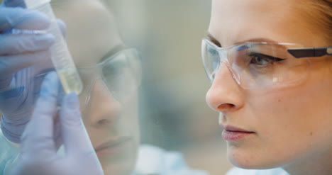 Scientist-Analyzing-Tubes-At-Laboratory-2