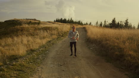 Energetic-guy-warming-legs-before-training-outdoor.-Active-man-jumping-on-place