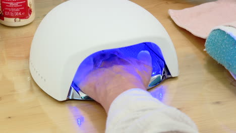 person using a uv nail dryer