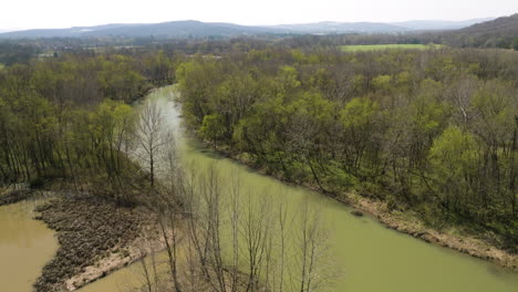 aerial rotate with tilt-up showing the murky waters of middle fork white river