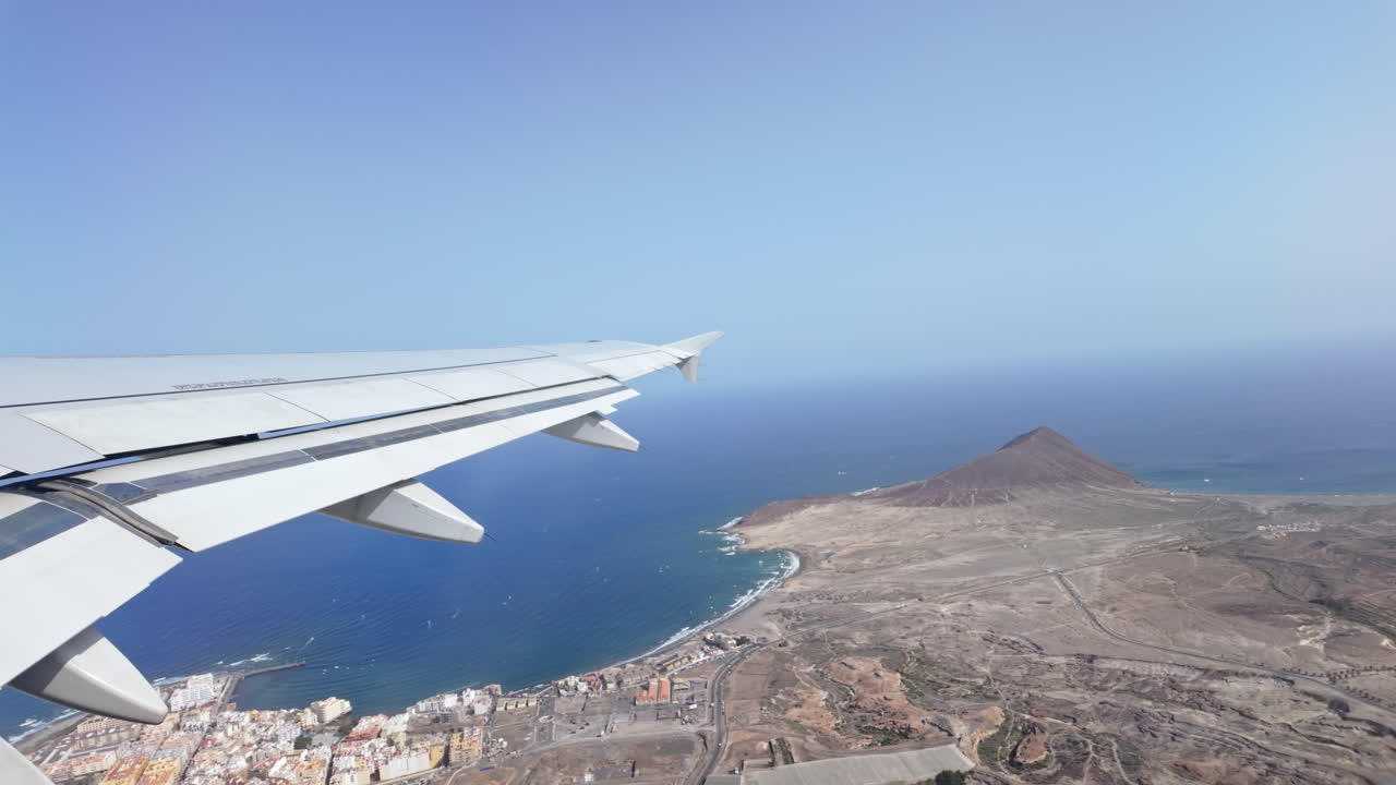 Plane flies over scenic coast, capturing tranquil ocean view