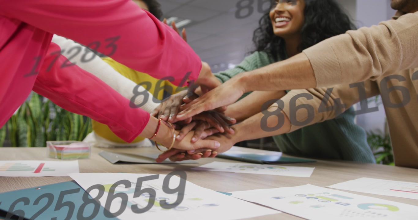 Animation of changing numbers against diverse colleagues stacking their hands together at office