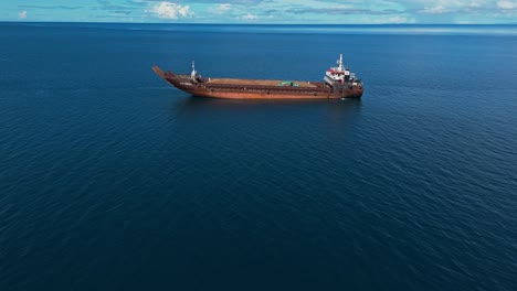 aerial fly by of mining barge in the ocean bay of the philippines