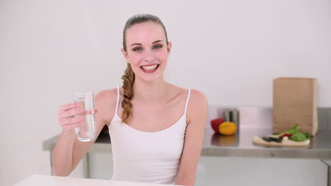 smiling model drinking glass of water