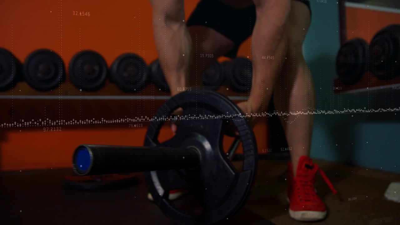 Male lifter reaching down, gripping loaded barbell in gym, pulling rows for strength training