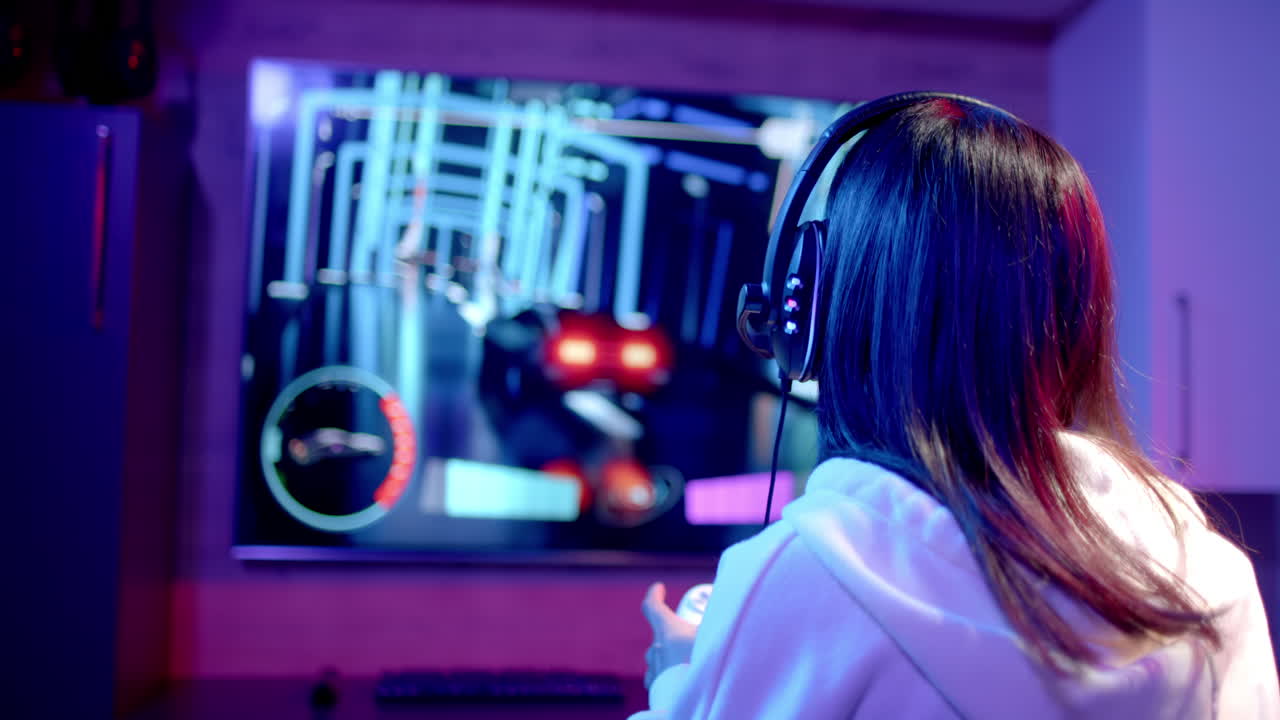 Playing video game, teenage girl wearing headphones focused on screen in gaming setup