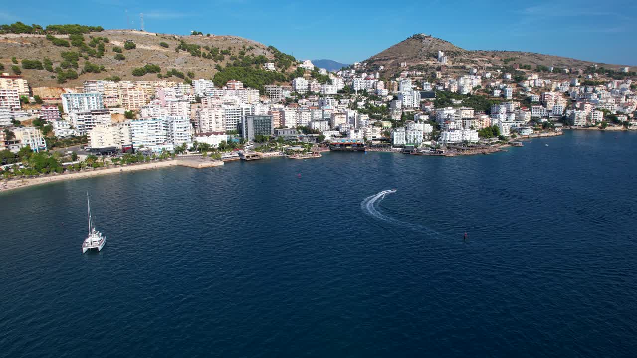 Summer Bliss: Embracing the Azure Beauty of Saranda's Coastal City, a Prime Tourist Destination with a Deep Blue Sea backdrop