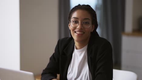 black girl secretary business woman sitting at table at office, portrait footage