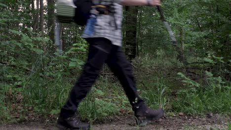 Backpacker-Walking-Past-Trees-On-a-Grey-Low-Light-Day