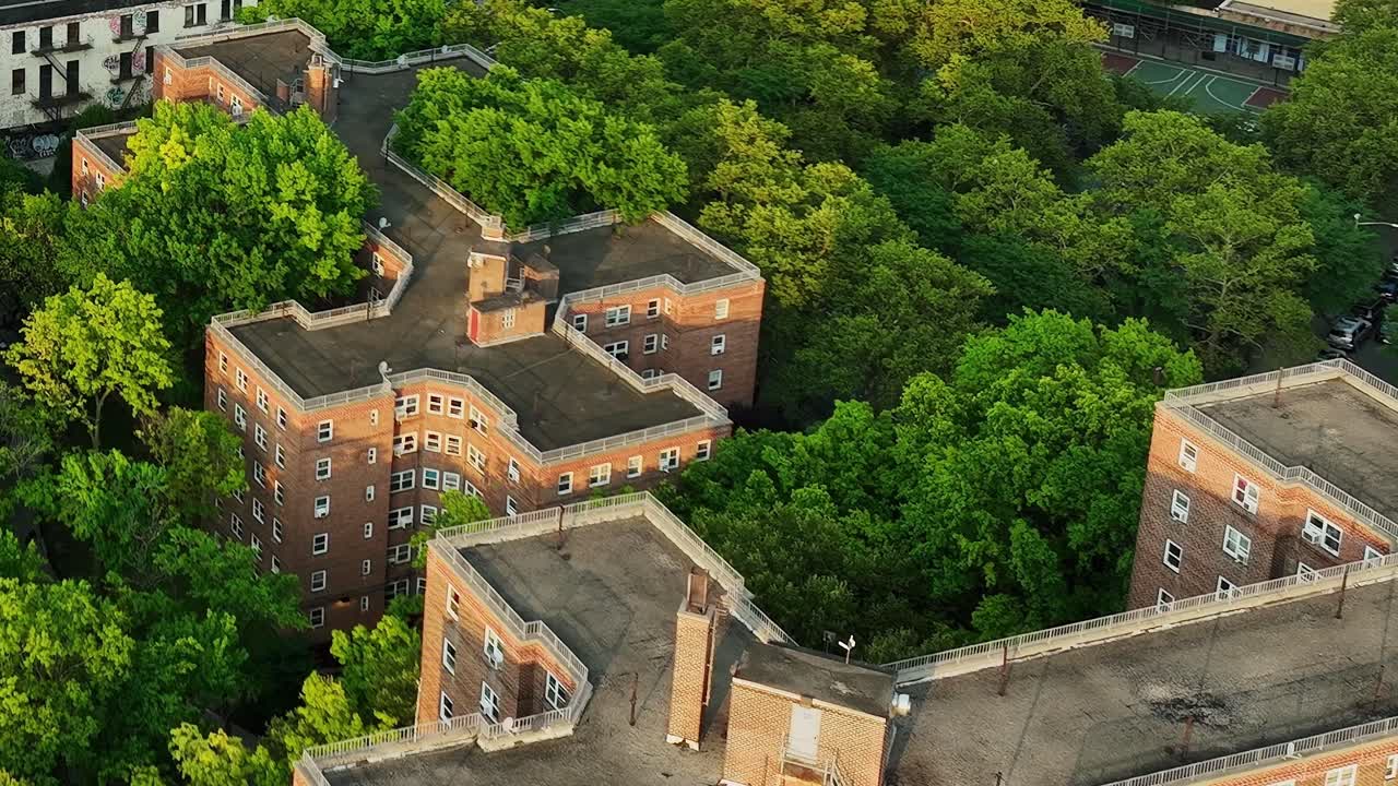 Drone view captures New York apartment buildings surrounded by trees