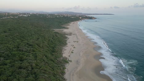 panoramic drone landscape unpolluted beach coastline forest in bacocho mexico, puerto escondido