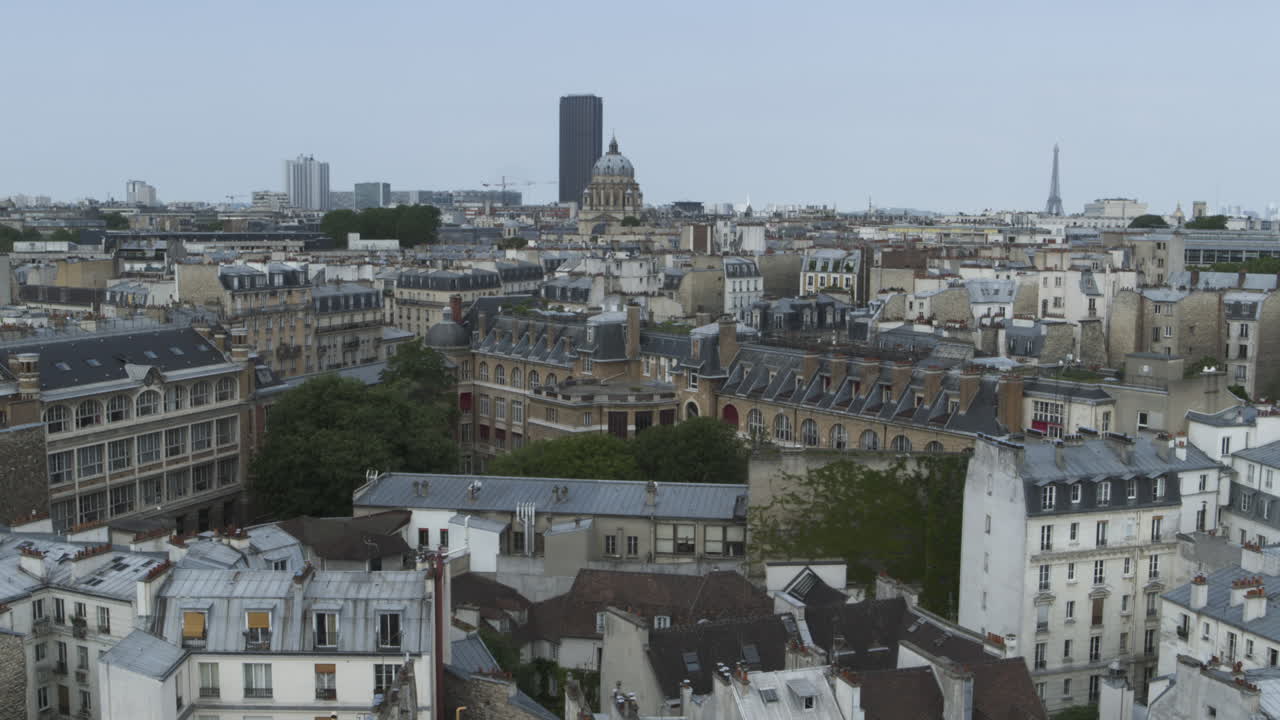 Drone shot of Paris landscape with eiffel tower, tour montparnasse then focusing on a typical parisian neighbourhood