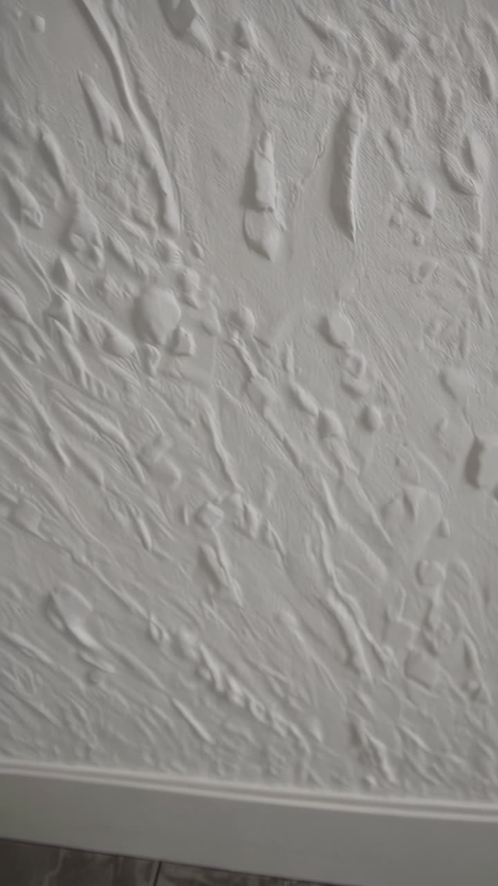 Textured White Wall with Baseboard and Flooring