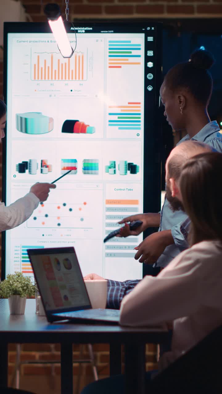 Vertical video: Diverse coworkers presenting analytics report, pointing ...