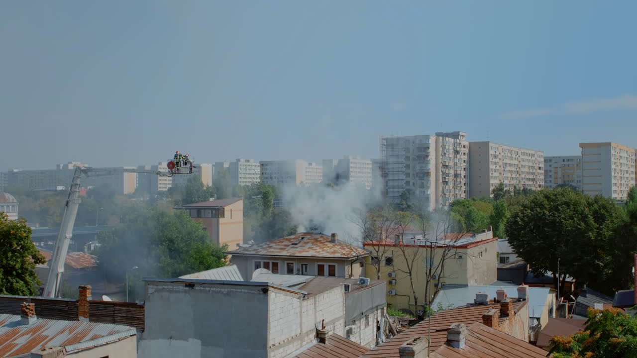 View of burning house and firefighters trying to extinguish fire