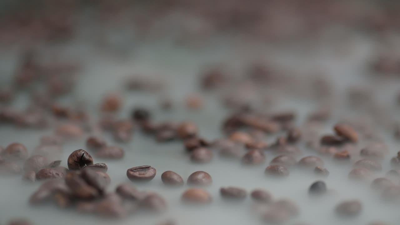 Close-up push in through the steaming coffee beans