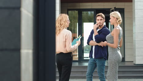 young couple buying luxury house together. estate agent advising house to couple