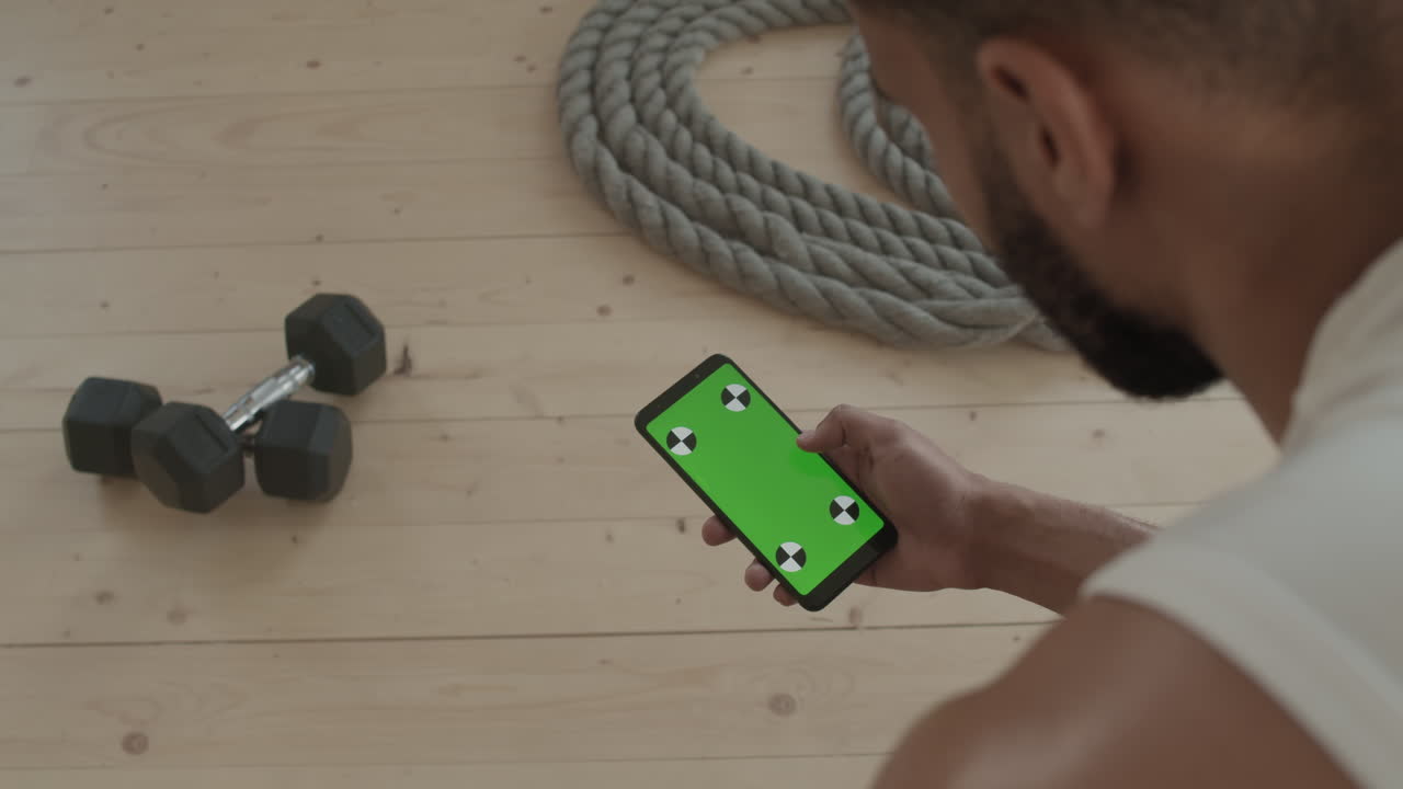 Sportsman With Smartphone At Gym Studio
