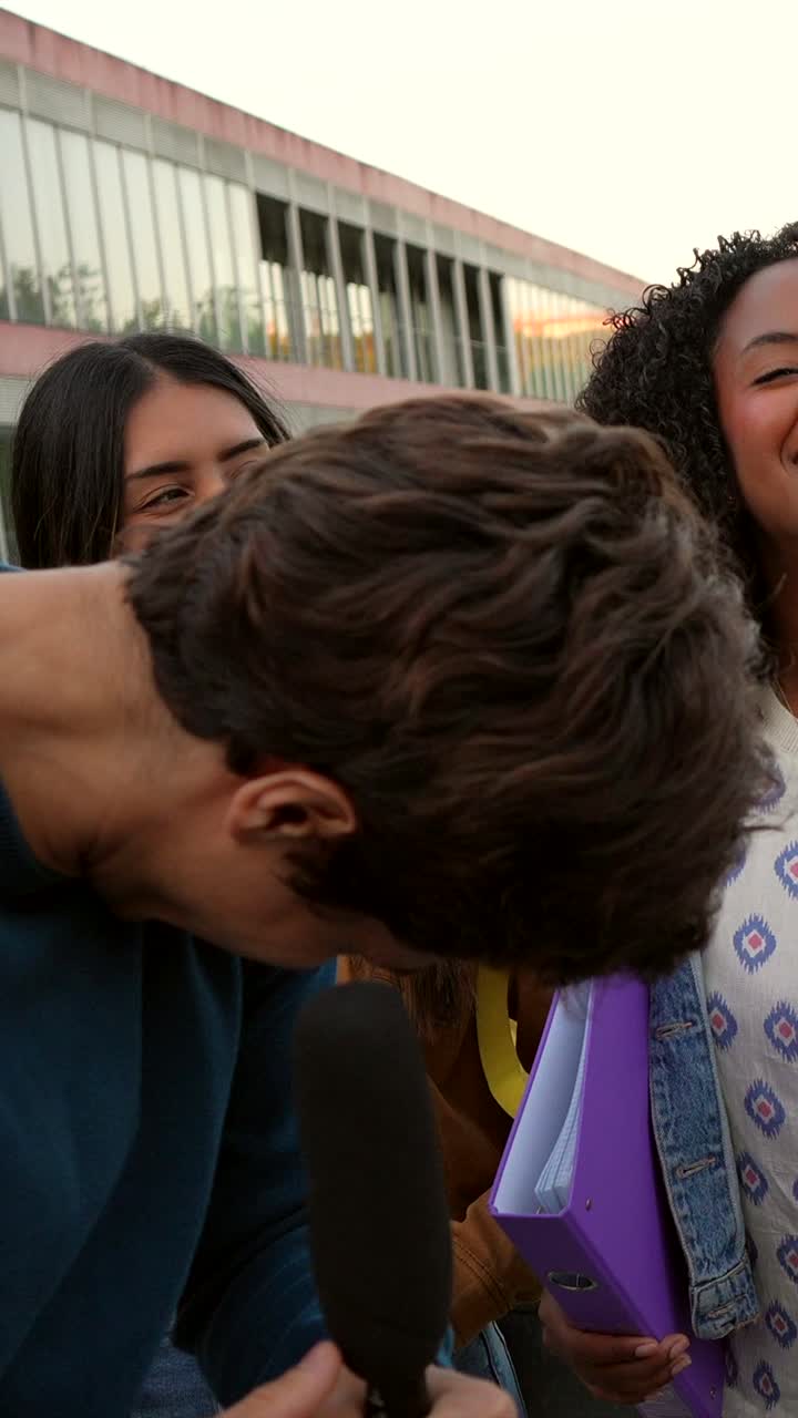 Students being interviewed with a microphone outdoors