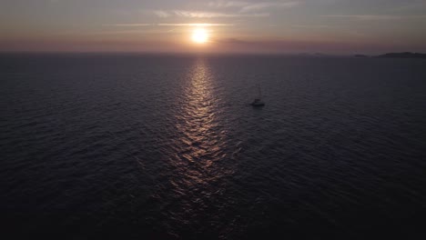 motorboat floating on speed in sea during sunset