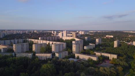 Smooth-aerial-top-view-flight-Panel-system-building,-prefabricated-housing-complex,-Berlin-Marzahn-East-Germany-golden-hour-2023