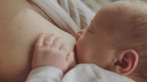 mother breastfeeding newborn baby