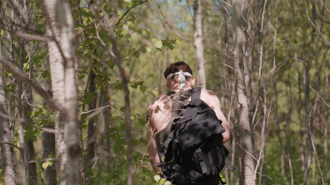 Back view of adventurer slipping in shoes while walking through dense jungle brush on uneven terrain struggling to maintain balance as roots and rocks cause boot to slide and ankle twist