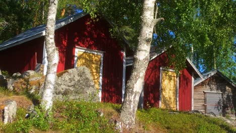 traditional nordic red barns, row of three old barns in sweden with typical colors