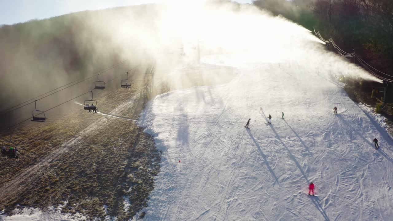 4K aerial drone Skiers on grass and snow Upstate New York
