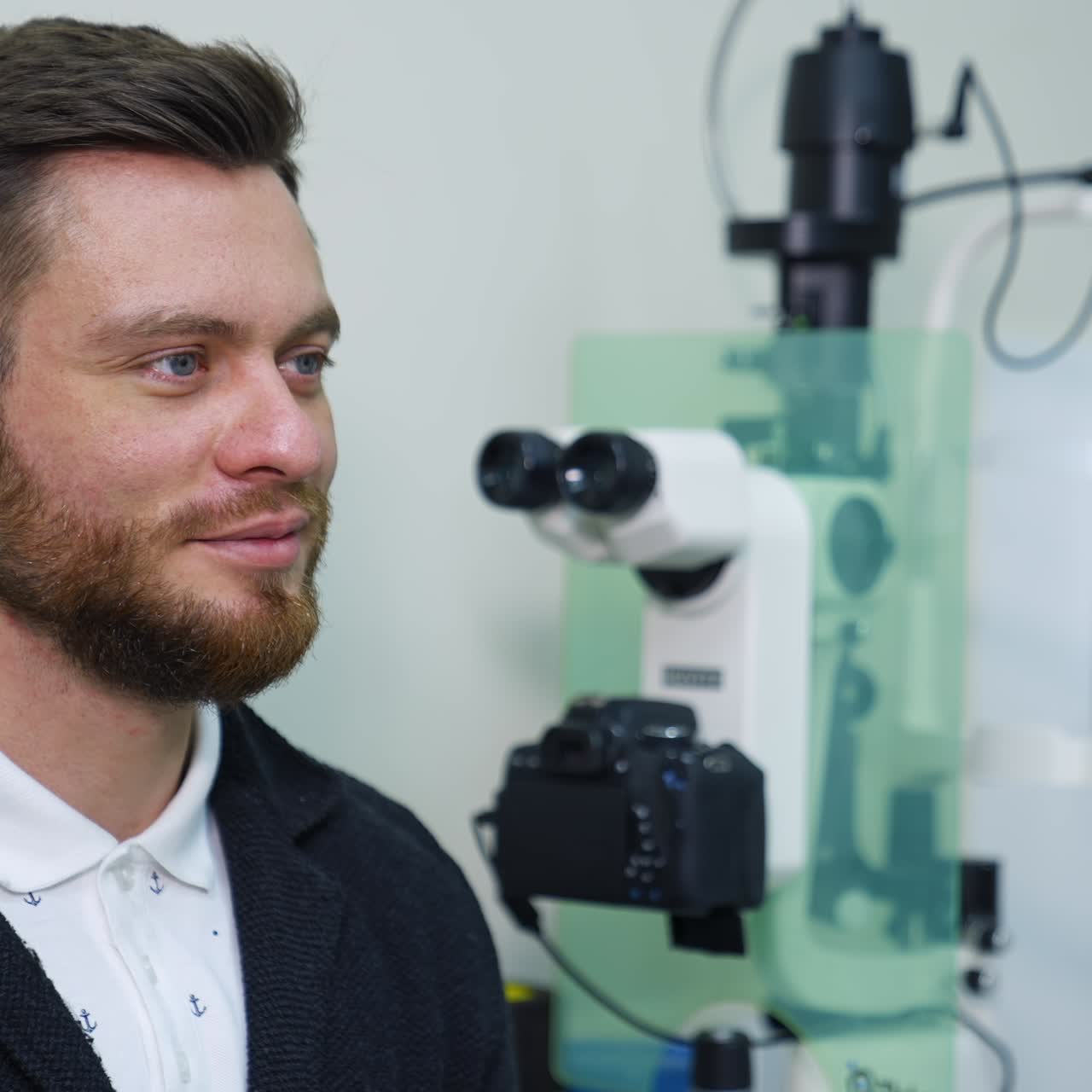 Handsome male checks vision in ophthalmological clinic. Optometrist trial frame. Healthcare concept