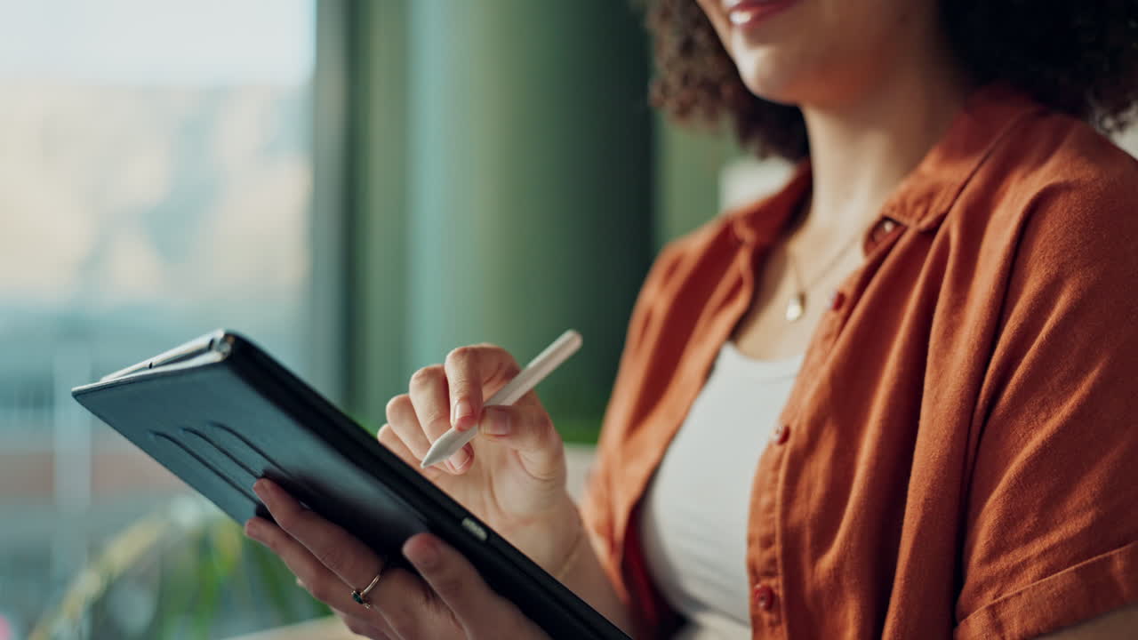 Woman using a tablet with a stylus