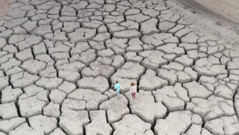 people walking on cracked earth