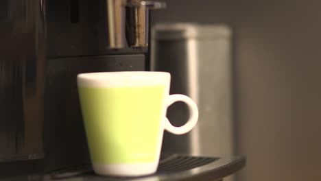 close up of a cup of coffee thats being made by a machine