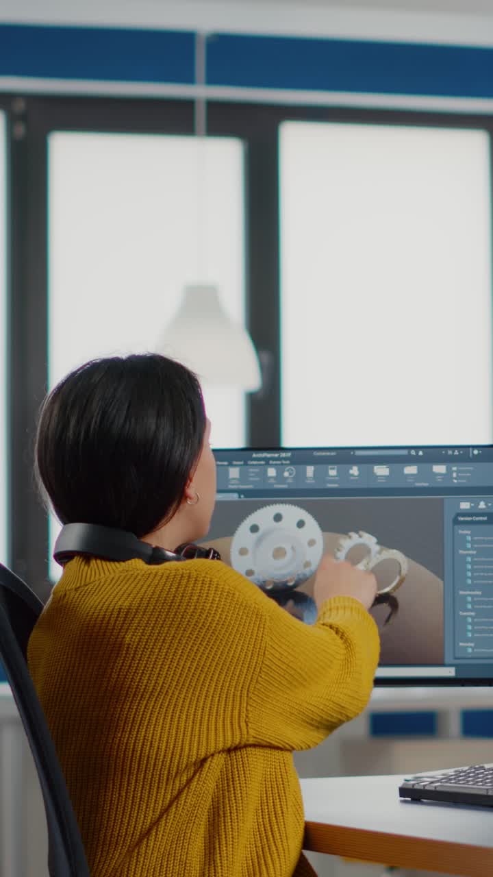 Vertical video Industrial designer discussing with woman engineer looking at pc