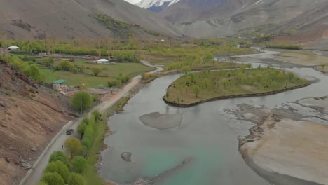 aerial view along road beside river in ghizer valley district in pakistan