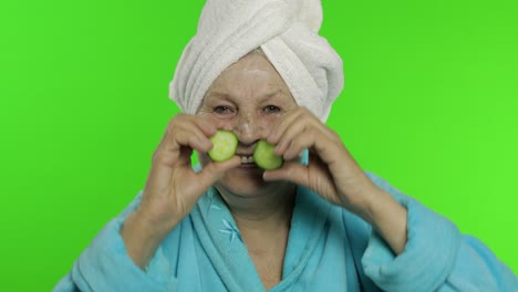 Elderly-grandmother-in-bathrobe-after-shower.-Old-woman-with-slices-of-cucumber