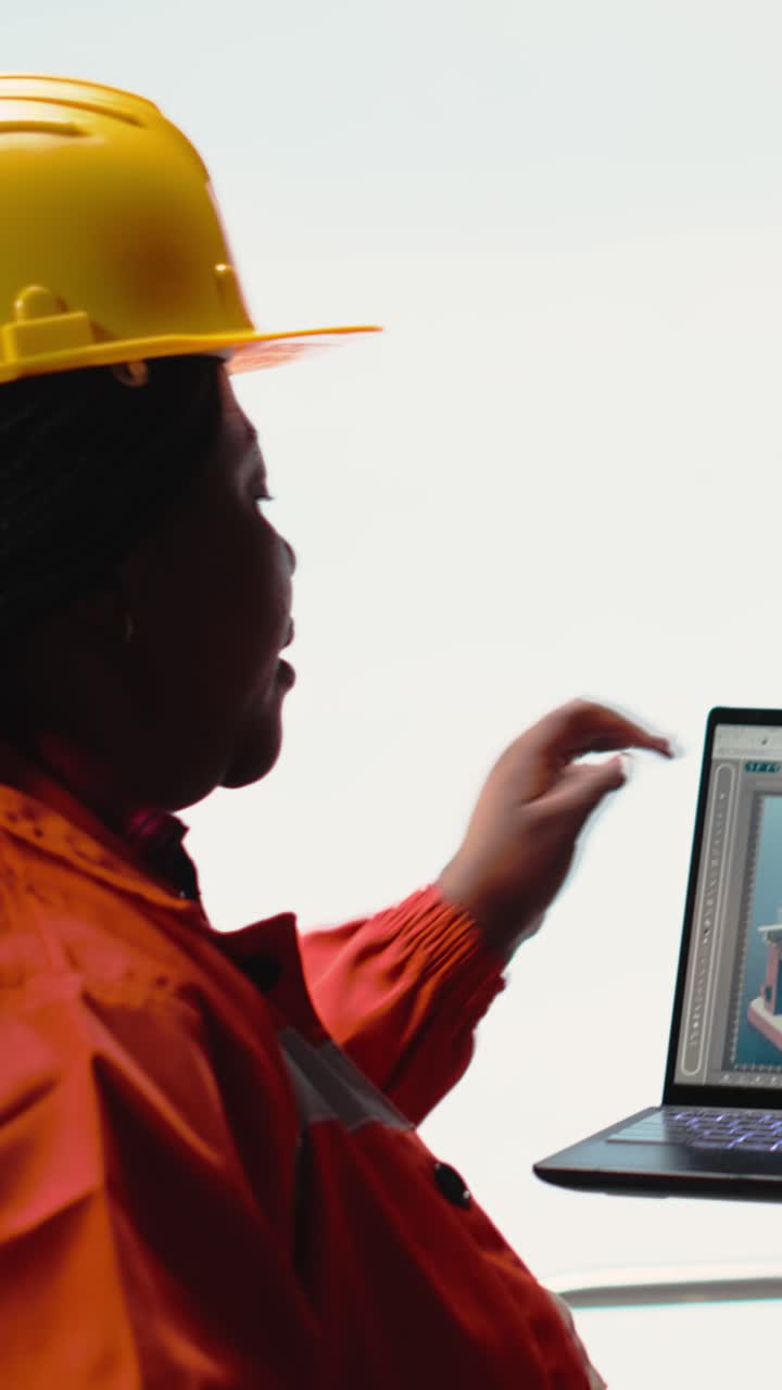 Vertical video Drilling barge engineering team on deck studying geological maps