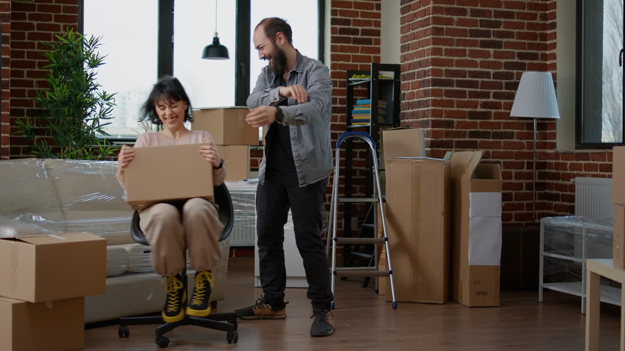Joyful married couple feeling happy about moving in new house