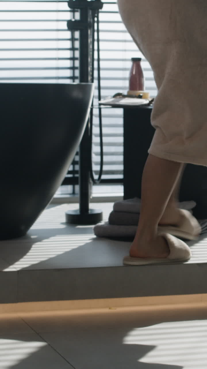 Woman in Bathrobe in a Modern Bathroom