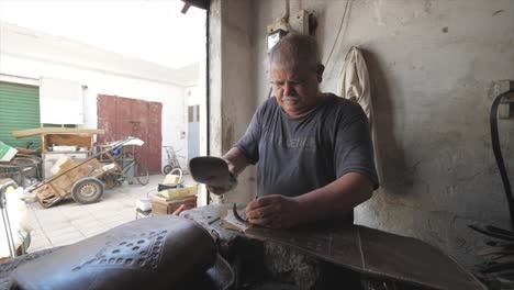 leather craftsman fixing, repairing, working and restoring leather material