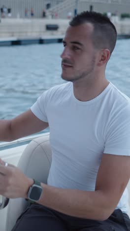 man driving a boat at sea