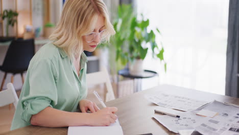 Woman-Takes-Notes-in-Notebook-During-Meeting