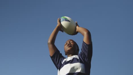 young adult female rugby player on a rugby pitch