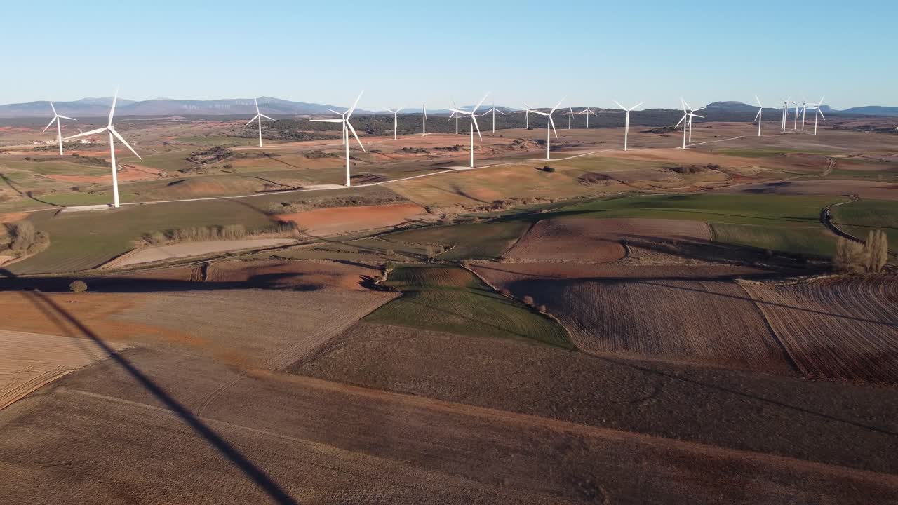 Windmills in field on sunny day