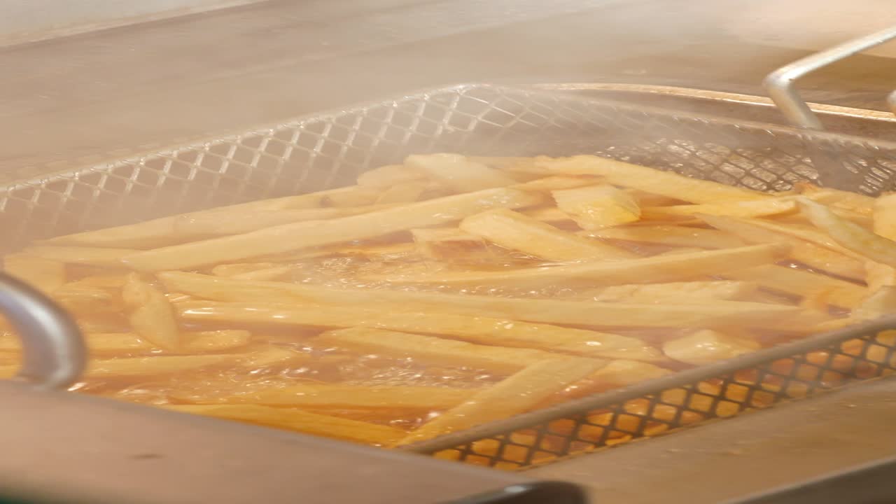 French Fries Being Fried in a Deep Fryer