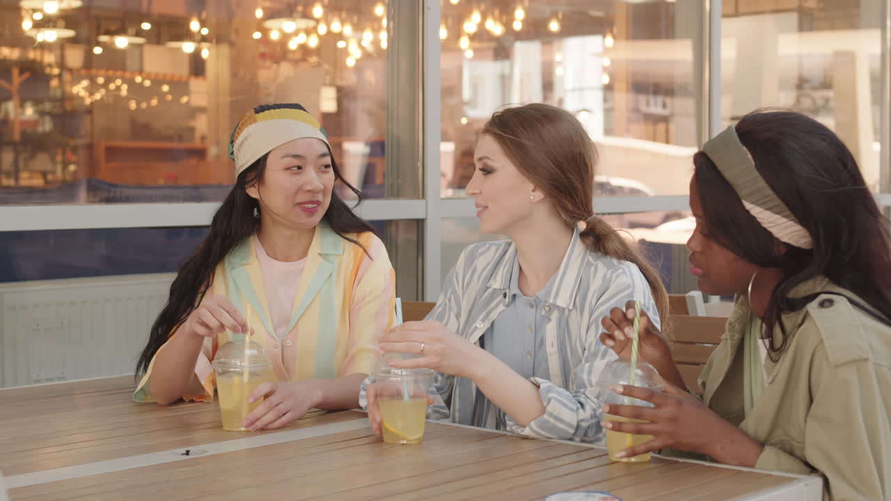 Girlfriends Chatting Outside Cafe
