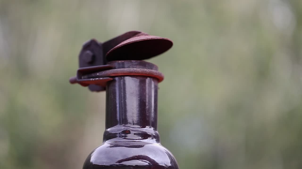 Black diesel smoke puffs from equipment exhaust pipe, close up view
