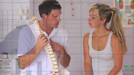 animation of graphs processing data over caucasian male doctor and female patient studying spine